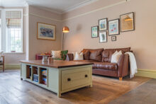 A beautiful bay window fills the snug with natural light.